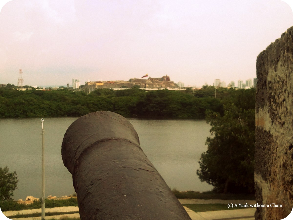A cannon and the Castillo de San Felipe