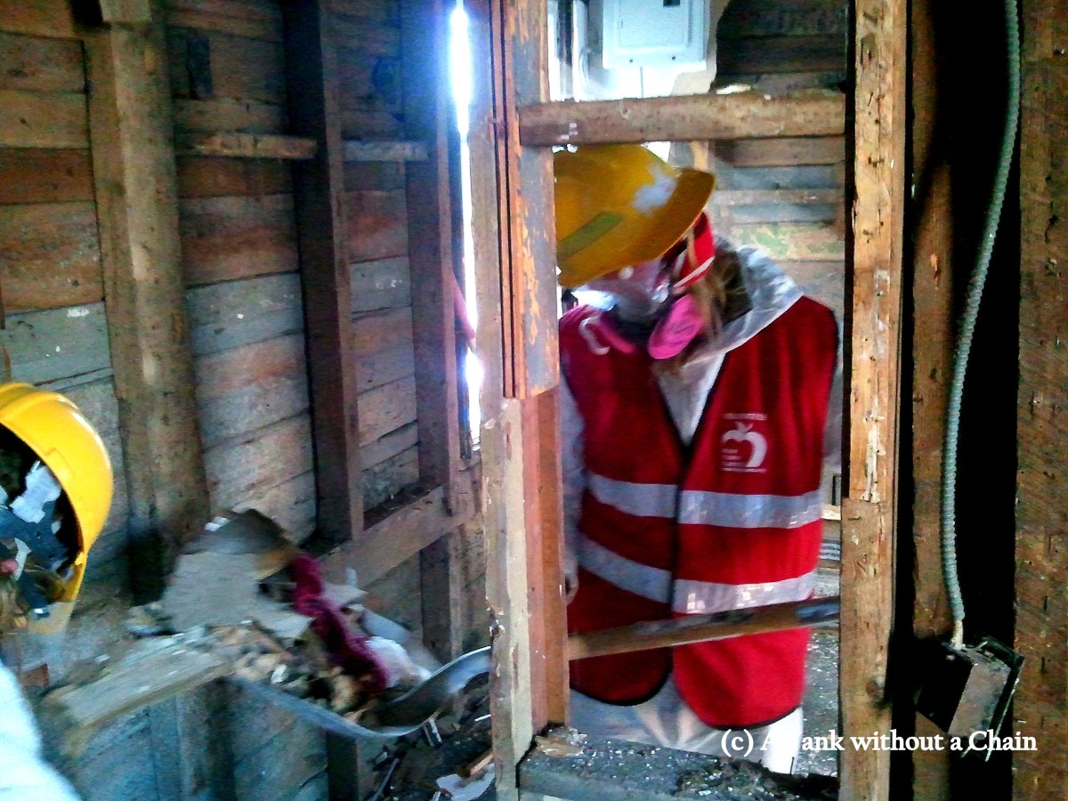 A New York Cares volunteer cleaning up debris