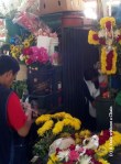 You can see men and women arranging flowers on the second floor of San Camilo Market