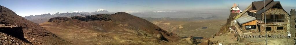The highest ski lift in the world is the red and white building in the back, while the front building is the ski lodge.