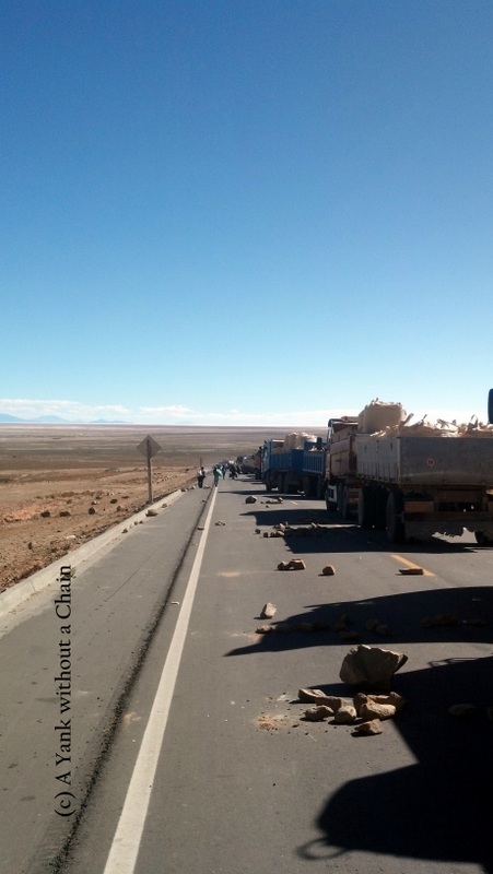Trucks wait on the road to Uyuni for the protest to be disassembled