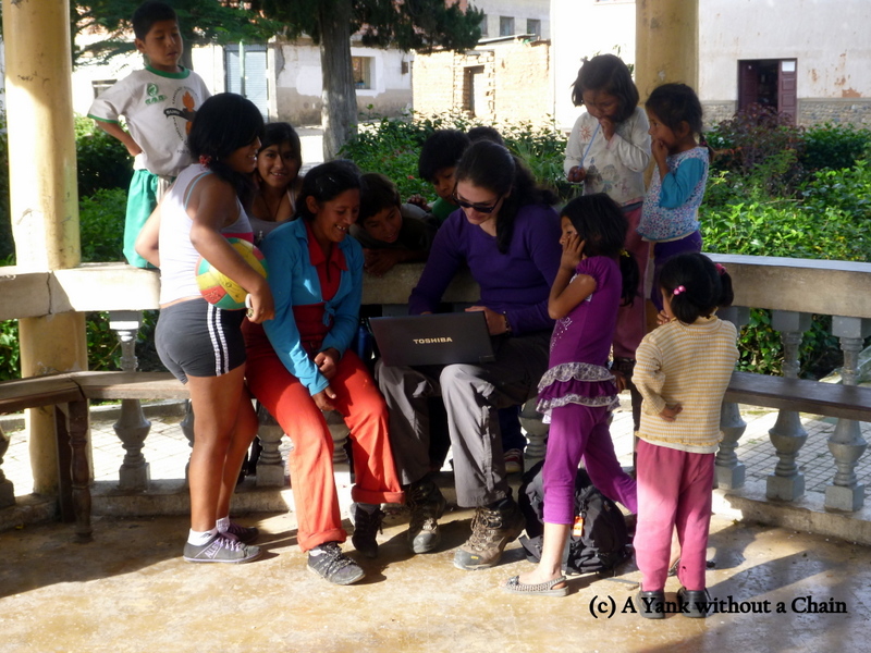 Showing the school kids in Suri photos from home.