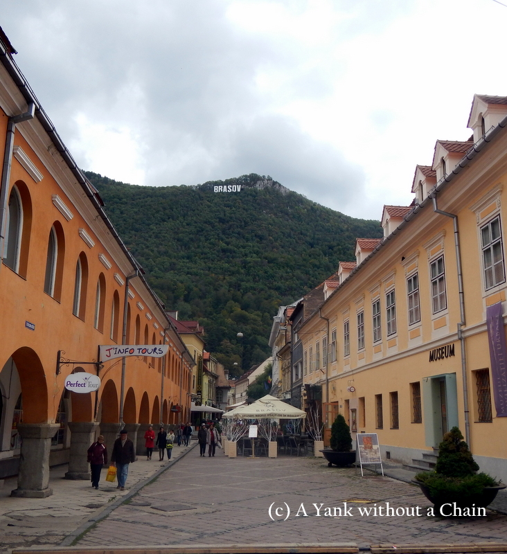 A street in Brasov with the Hollywood-like sign in the background