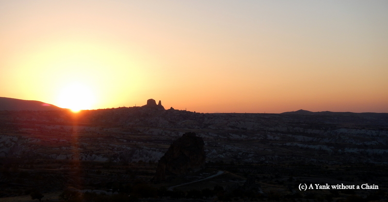 The sun setting behind Uchisar Castle