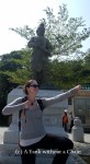 Posing with an archer statue at the Big Buddha site