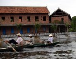 Rowers using their feet in Tam Coc