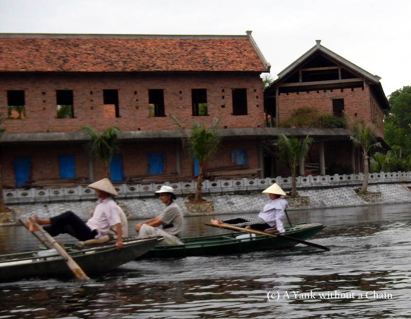 Rowers using their feet in Tam Coc