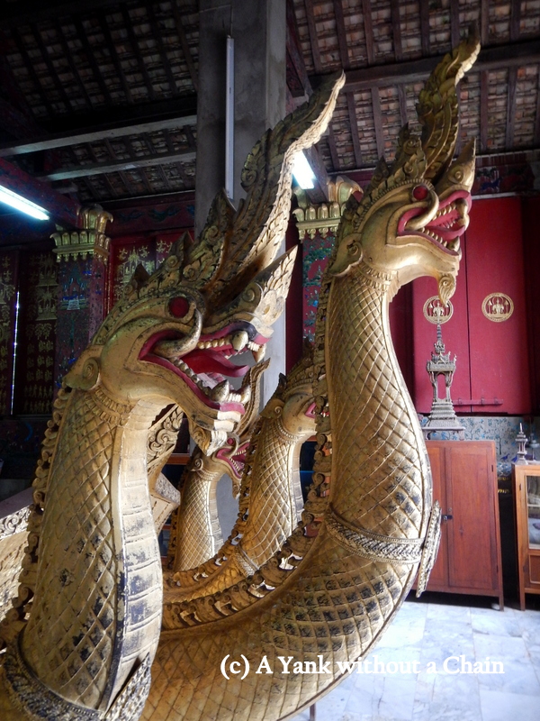Nagas (sacred water spirits) on the front of a coach at Vat Xieng Thong in Luang Prabang
