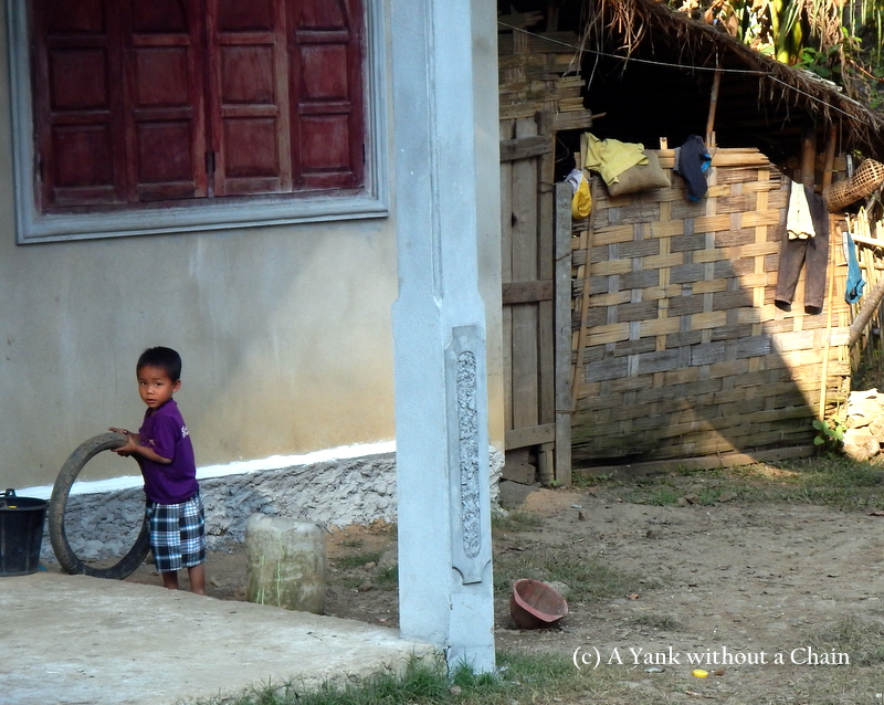 A child playing with a tire in Ban Houay Thong