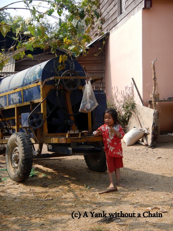 A young girl outside her home near the Kong Lor cave