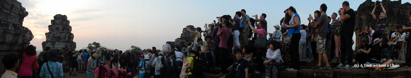 Tourists taking photos of the sunset at Phnom Bakheng