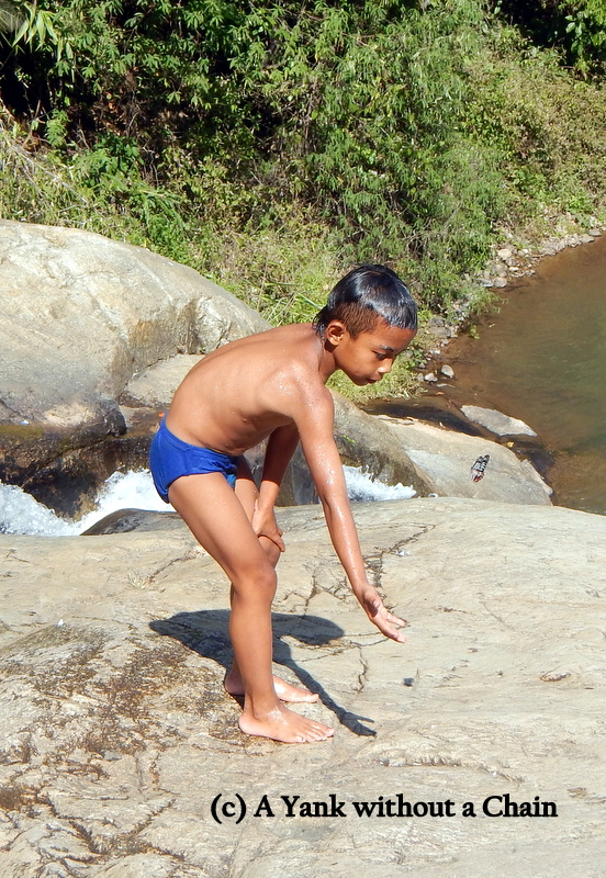 The local boy tries to capture a butterfly