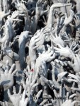 Hands reaching up from the ground outside the White Temple
