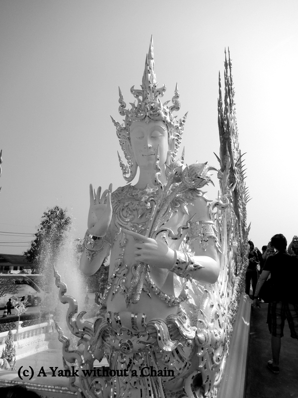 A figure outside the White Temple in Chiang Rai
