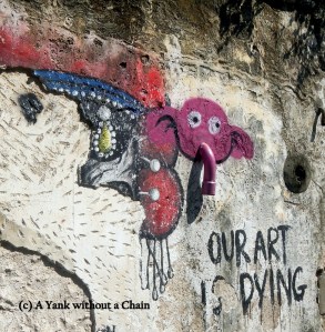A pink elephant and a cynical message on a wall near Lebuh Armenian in George Town, Penang