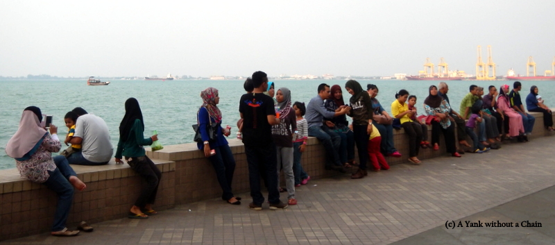 People in George Town, Penang waiting for sunset on the Strait of Malacca