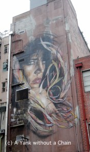 A gigantic mural by Adnate that rises above Tattersall's Lane in Melbourne's CBD
