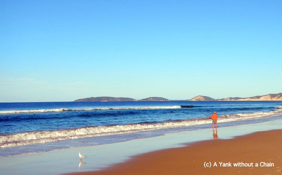 A man fishing on Rainbow Beach