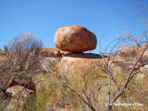 The impressive balancing act of one of the granite boulders that is part of the Devils Marbles conservation park in central Australia